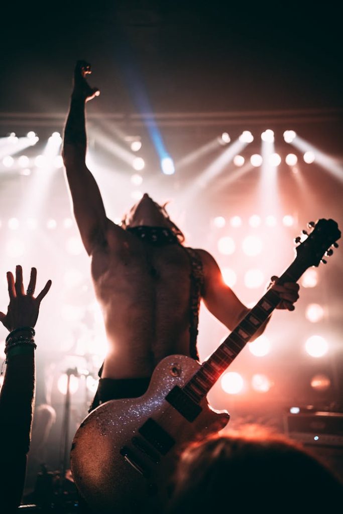 pexels photo 11963114 Dynamic stage performance of a guitarist during a live rock concert.